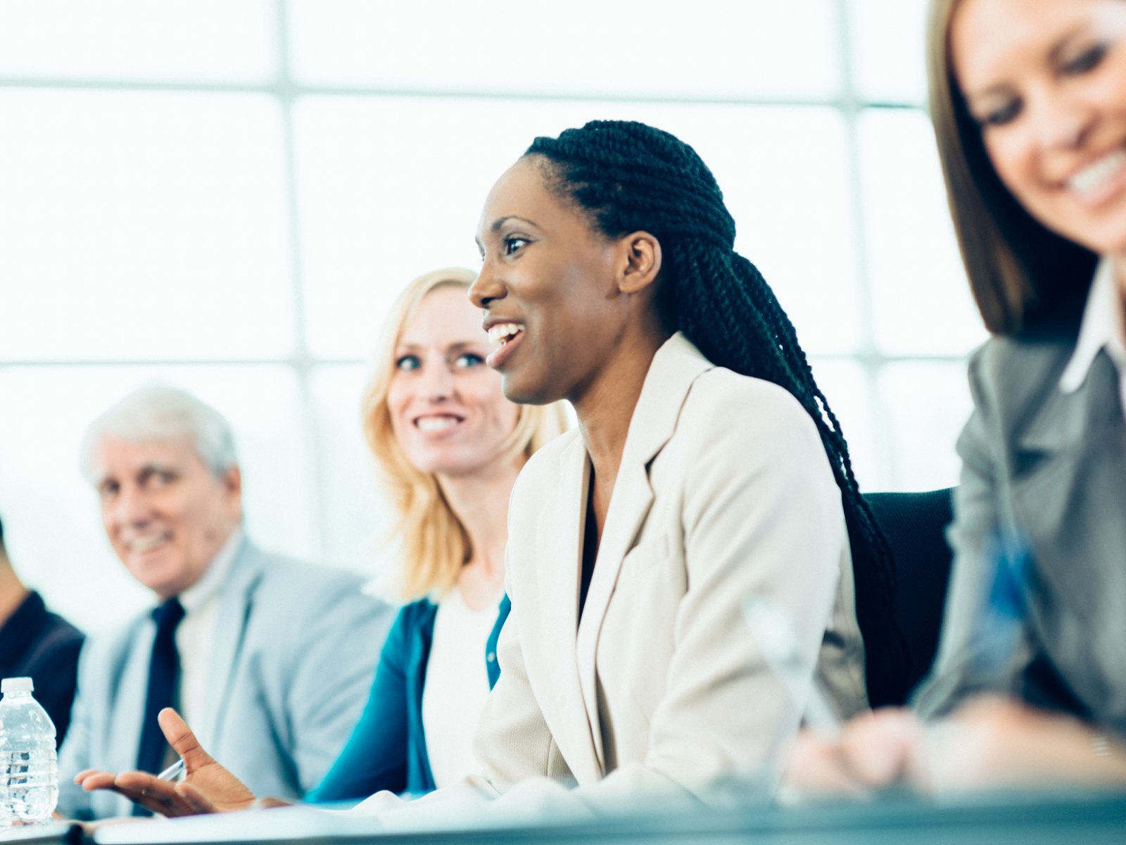 A team in a working session, one colleague speaking while others listen
